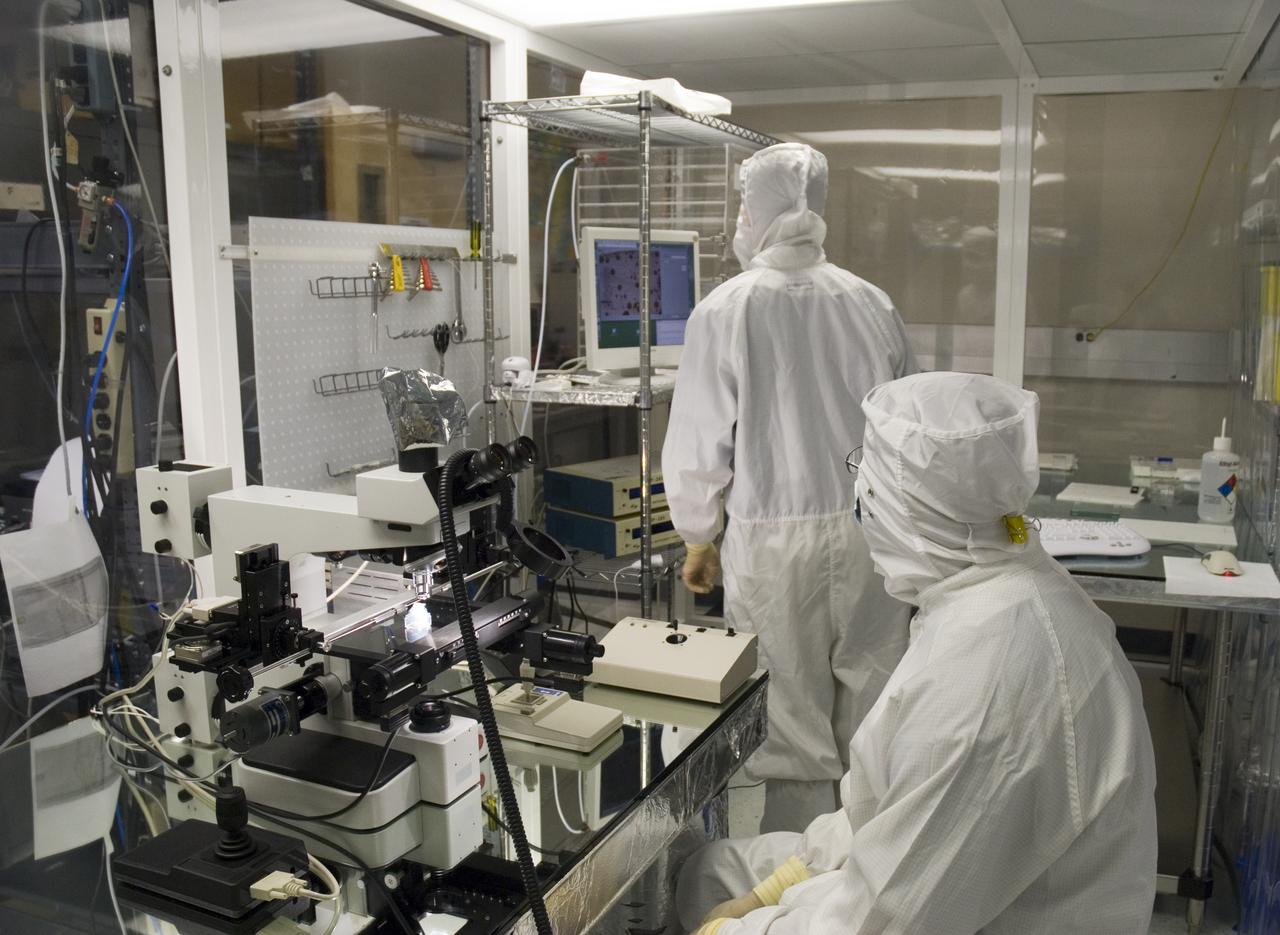 Stardust sample analysis @ UC Berkeley clean room  with Dr Scott Sandford, NASA Ames Astrophysicist - mission samples provided to UC Berkeley for analysis by NASA  Berkeley researchers Zack Gainsforth (seated) and Chris Snead working with sample encased in aerogel