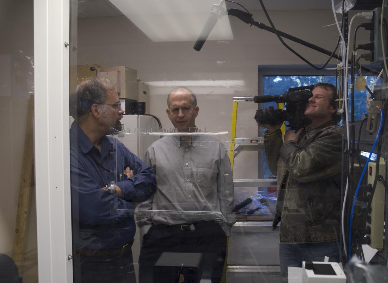 Stardust sample analysis @ UC Berkeley clean room  - mission samples provided to UC Berkeley for analysis by NASA:  (r)  Dr Andrew Westphal, Berkeley Physicist with Dr Scott Sandford, NASA Ames Astrophysicist (l)  oversee sample analysis - Jess Carpenter NASA/Ames videographer documents the event