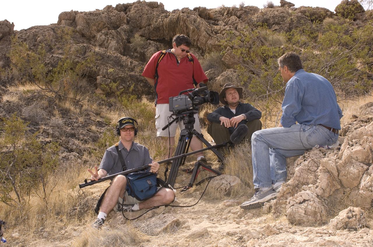 Spaceward Bound event in the Mojave Deser , CA (an outreach exercise) with Dr Chris McKay and Ames Education department personnel Brian Day, Barbara Bazar accompaning teachers (learning for the the classroom) Ames video crew L-R, Eric Land (on sound), Bill Moede (on camera) and Jessie Carpenter interview Chris McKay