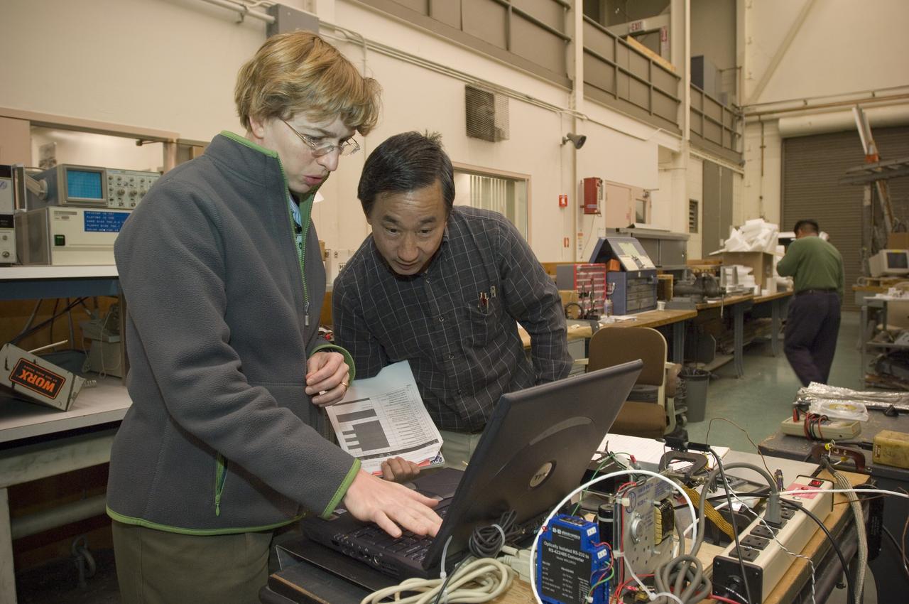 Lunar CRater Observation and Sensing Satellite (LCROSS) and P.I. at NASA Ames Research Center  - Total Luminance Photometer lens and electronics units on shake table in N-2444 EEL Laboratory: Kim Ennico and Gi Kojima check electronics
