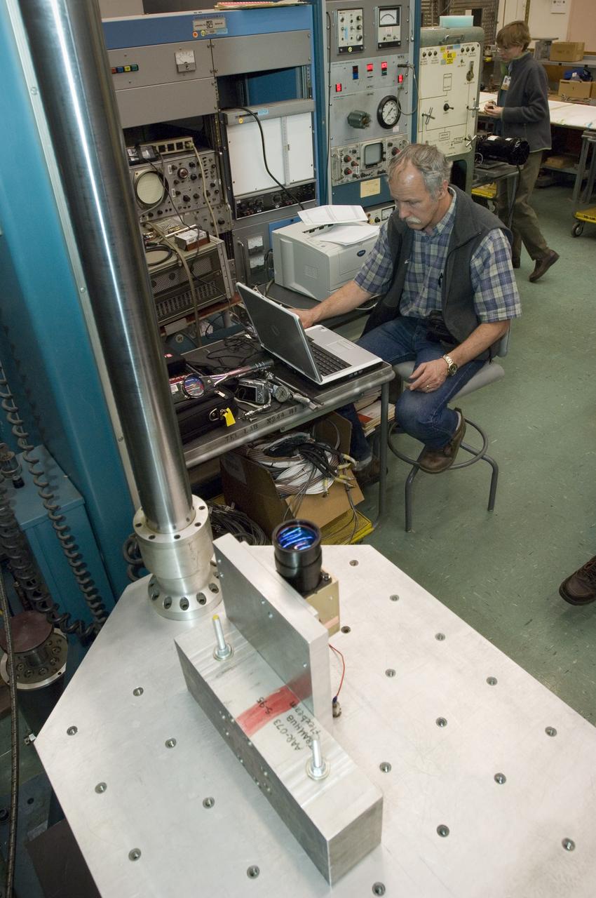 Lunar CRater Observation and Sensing Satellite (LCROSS) and P.I. at NASA Ames Research Center - Total Luminance Photometer lens and electronics units on shake table in N-2444 EEL Laboratory with Lynn Hofland (techician/operator EEL) oversees test run