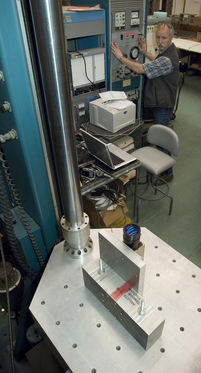 Lunar CRater Observation and Sensing Satellite (LCROSS) and P.I. at NASA Ames Research Center - Total Luminance Photometer lens and electronics units on shake table in N-2444 EEL Laboratory with Lynn Hofland (techician/operator EEL) oversees test run