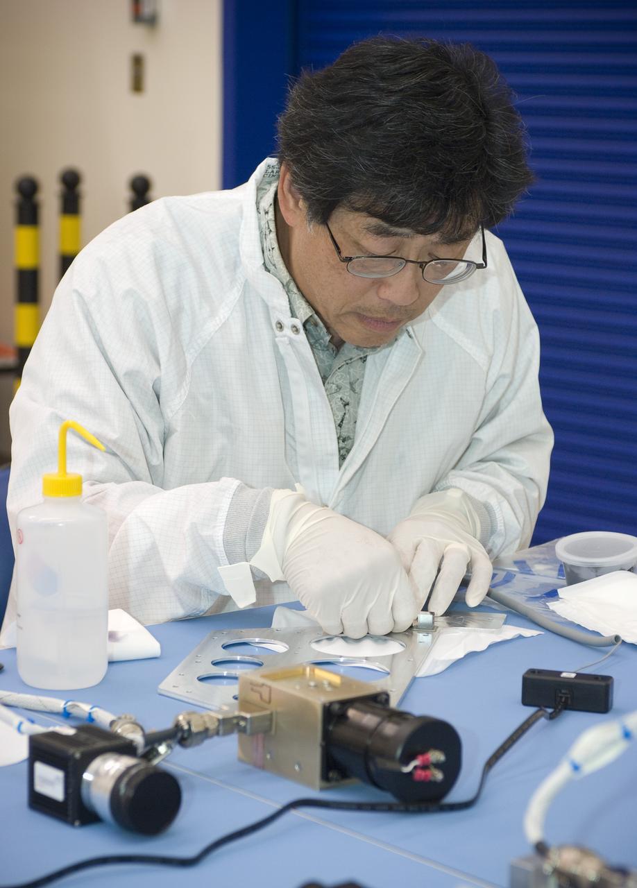 LCROSS flight hardware in clean room at Ames N-240. EEL personnel fabricating testing components with Jerry Wang of Ames, Engineering Evaluation lab