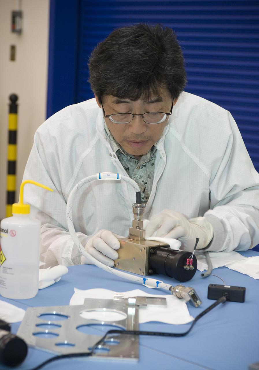 LCROSS flight hardware in clean room at Ames N-240. EEL personnel fabricating testing components with Jerry Wang of Ames, Engineering Evaluation lab