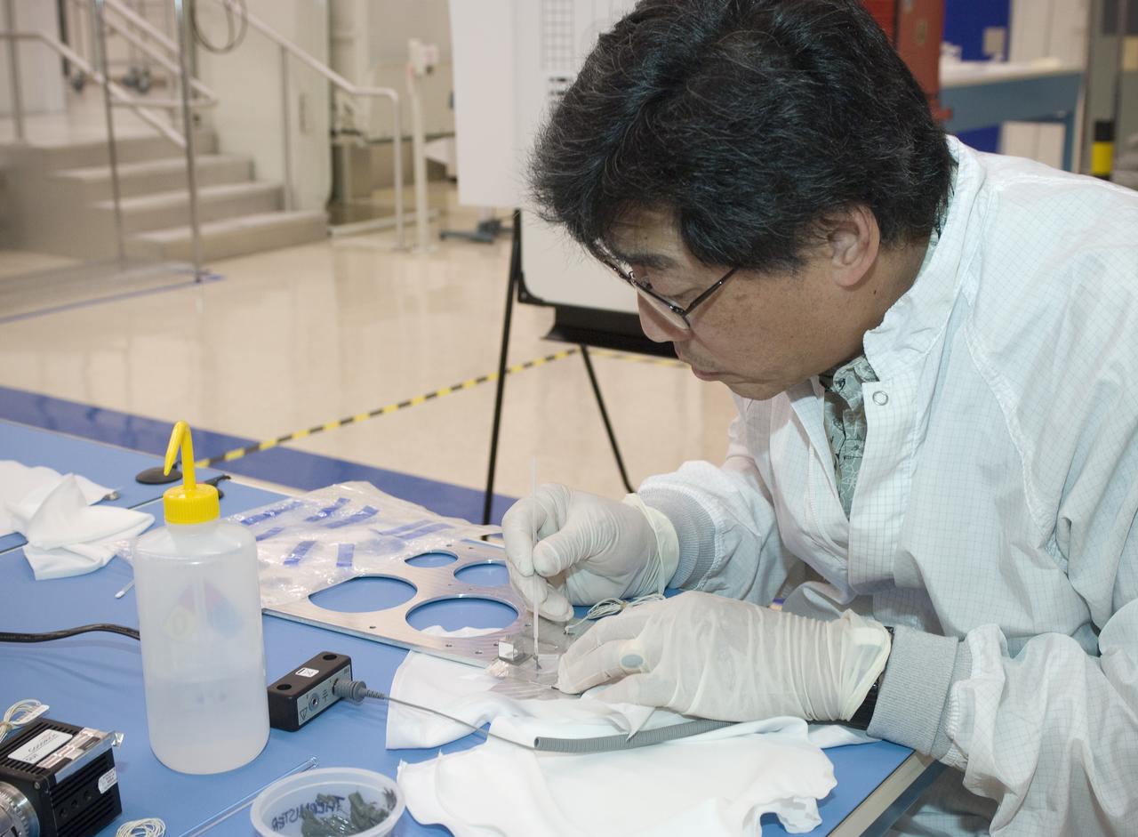 LCROSS flight hardware in clean room at Ames N-240. EEL personnel fabricating testing components with Jerry Wang of Ames, Engineering Evaluation lab