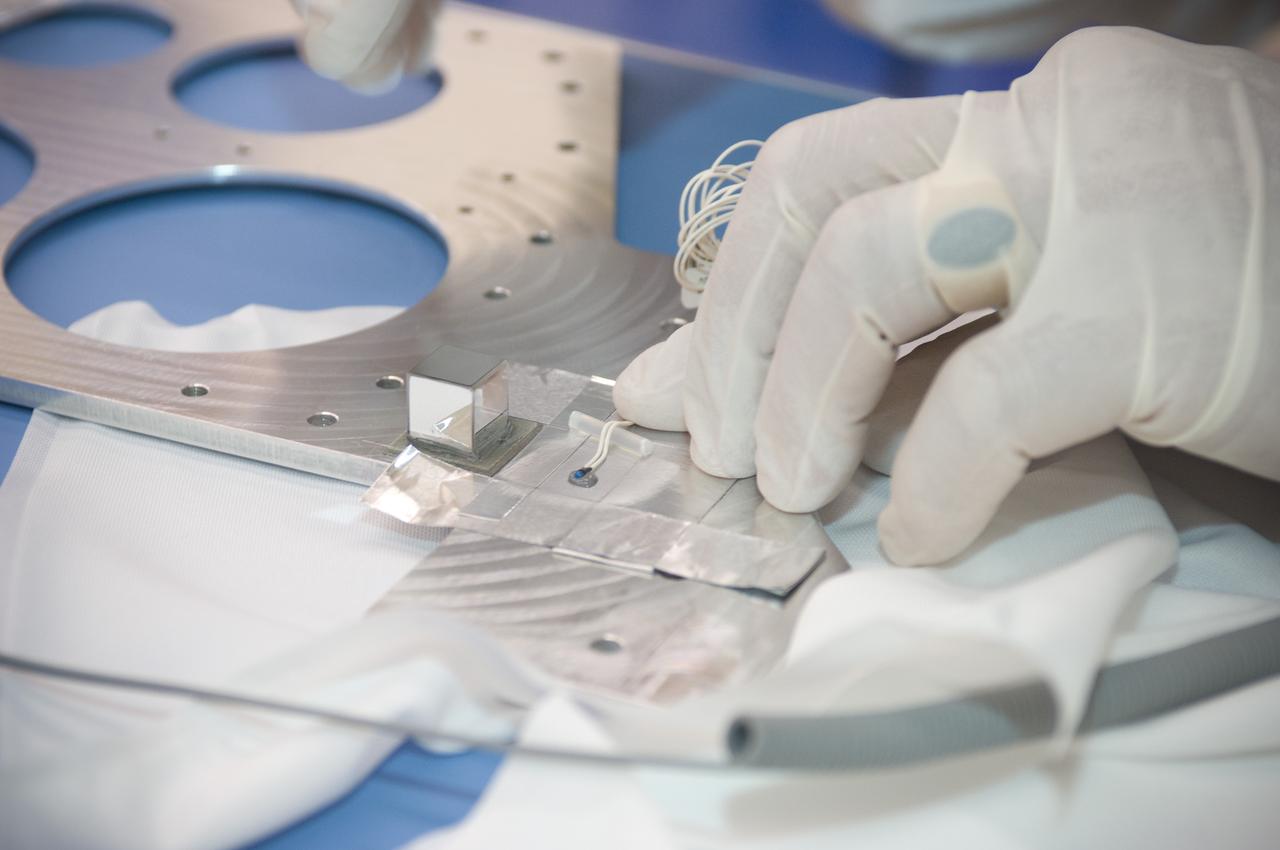 LCROSS flight hardware in clean room at Ames N-240. EEL personnel fabricating testing components with Jerry Wang of Ames, Engineering Evaluation lab