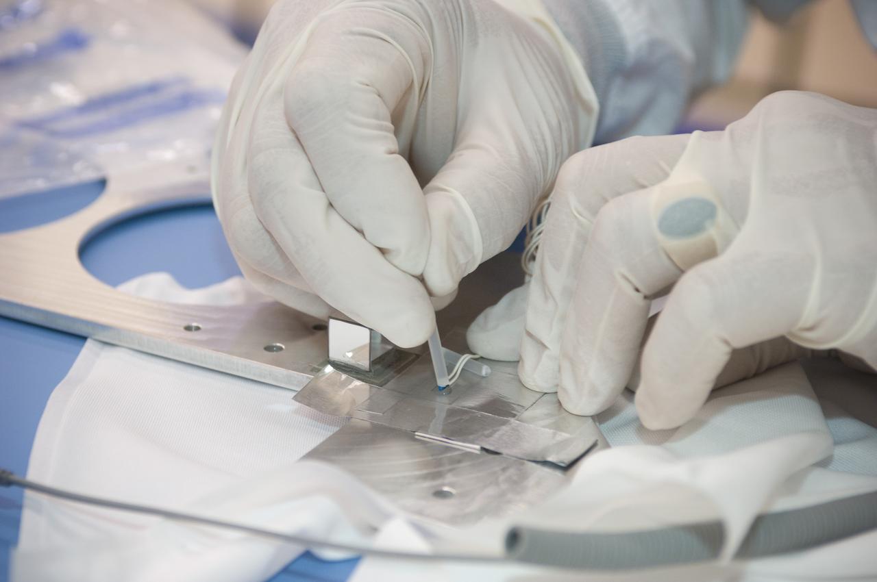 LCROSS flight hardware in clean room at Ames N-240. EEL personnel fabricating testing components with Jerry Wang of Ames, Engineering Evaluation lab
