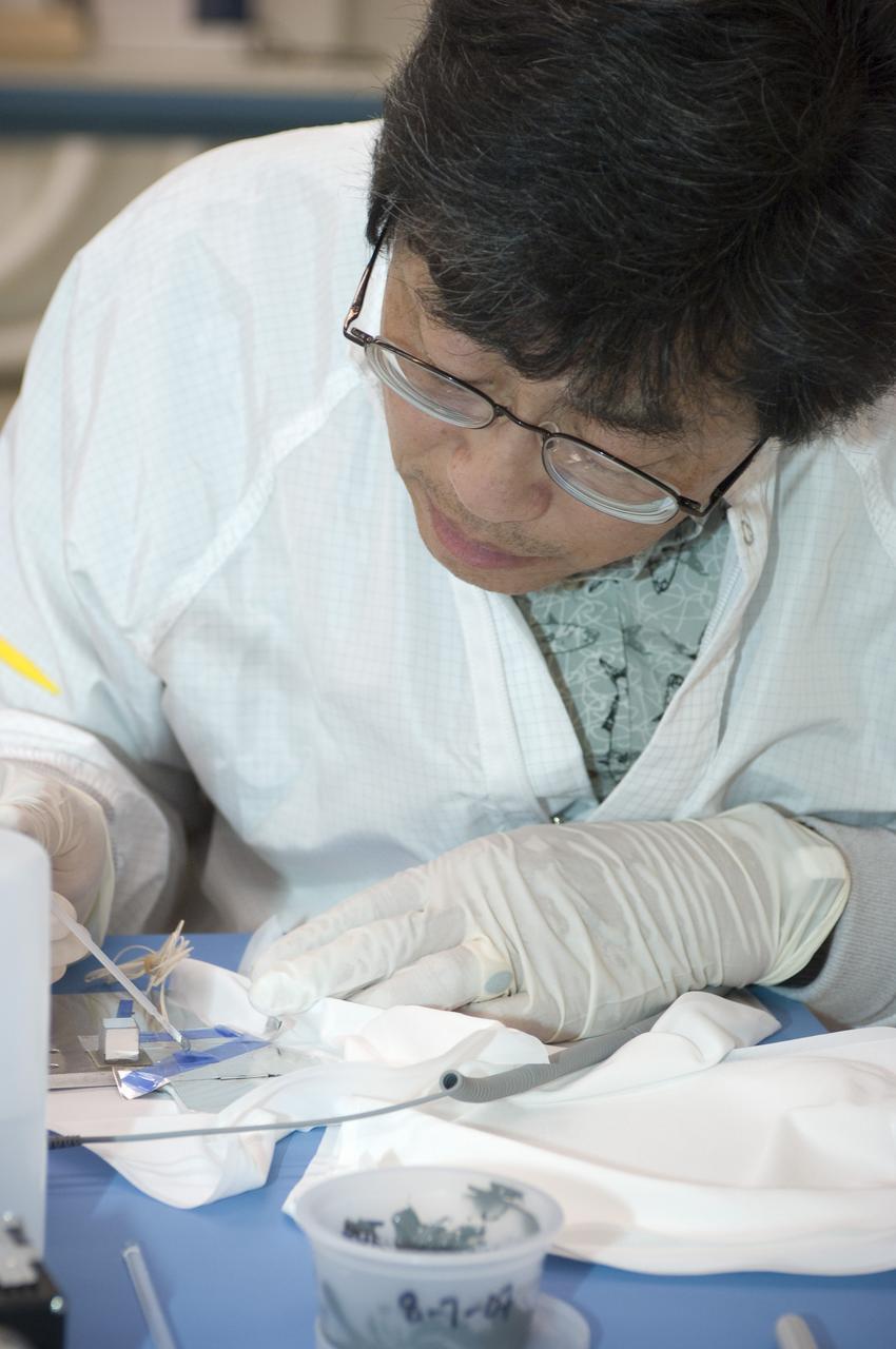 LCROSS flight hardware in clean room at Ames N-240. EEL personnel fabricating testing components with Jerry Wang of Ames, Engineering Evaluation lab