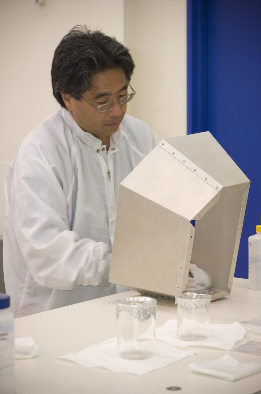 LCROSS flight hardware in clean room at Ames N-240. EEL personnel fabricating testing components with Glen Sasaki  of Ames, Engineering Evaluation lab