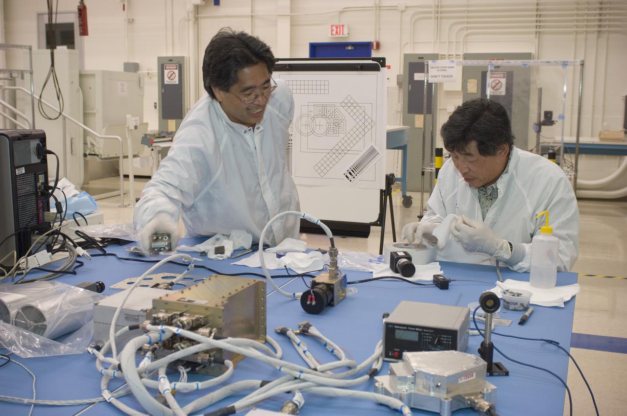 LCROSS flight hardware in clean room at Ames N-240. with P.I.'s and EEL personnel preforming various tests (Jerry Wang (R, seated) and Glen Sasaki (L, standing)