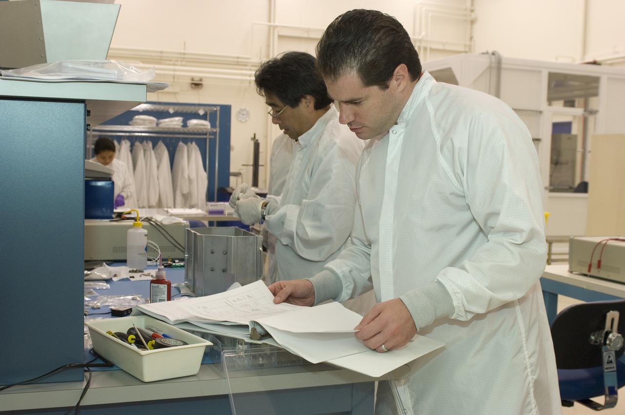 LCROSS flight hardware in clean room at Ames N-240. with P.I.'s and EEL personnel preforming various tasks,  with P. I. Tony Colaprete ( Glen Sasaki of Ames, Engineering Evaluation lab in background)