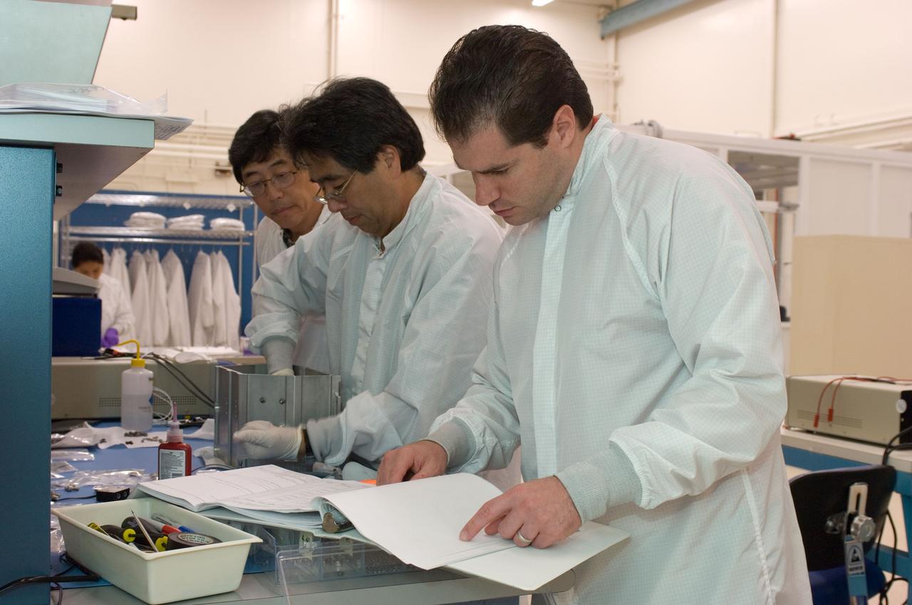 LCROSS flight hardware in clean room at Ames N-240. with P.I.'s and EEL personnel preforming various tasks. Tony Colaprete LCROSS P. I. in foreground, Glen Sasaki and Jerry Wang Ames Electrical Evaluation Lab