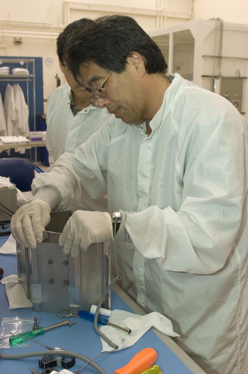 LCROSS flight hardware in clean room at Ames N-240. EEL personnel fabricating & assembling components with Glen Sasaki  of Ames, Engineering Evaluation lab