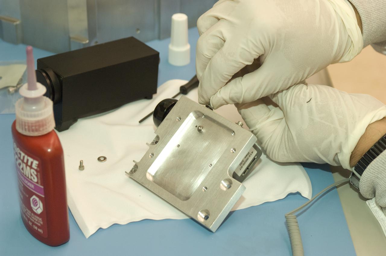LCROSS flight hardware in clean room at Ames N-240. EEL personnel fabricating & assembling components with Glen Sasaki  of Ames, Engineering Evaluation lab