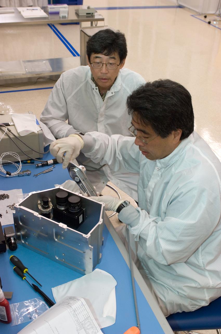 LCROSS flight hardware in clean room at Ames N-240. with P.I.'s and EEL personnel preforming various tasks during assembly Gene Sasaki (frt) and Jerry Wang (bk)