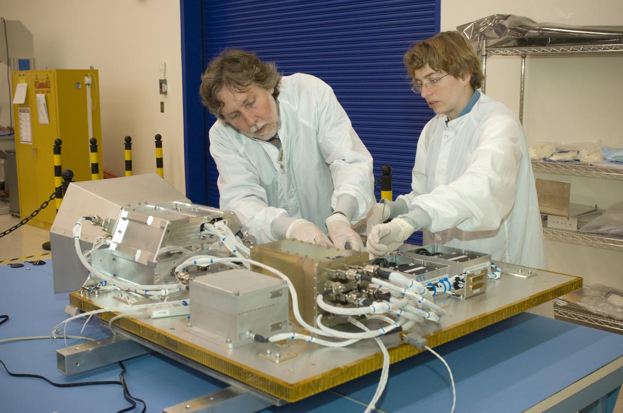 LCROSS flight hardware in clean room at Ames N-240. with P.I.'s and EEL personnel preforming various tests  Kim Ennico (r) and Dana Lynch (l)