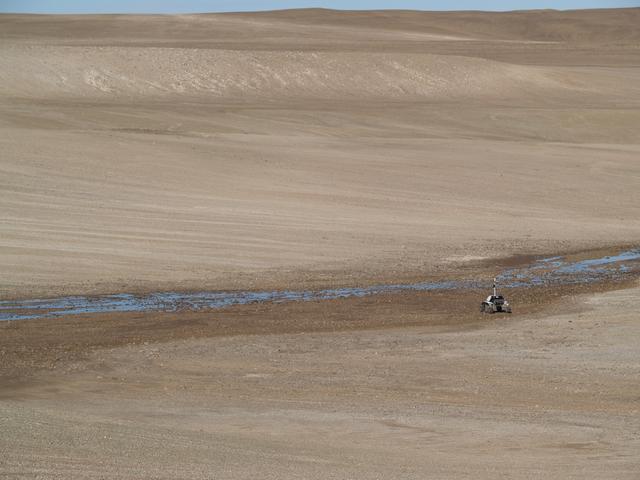 K-10 Black crossing snow melt on Devon Island, Canada. photo credit NASA/Lorenzo Fluckiger.