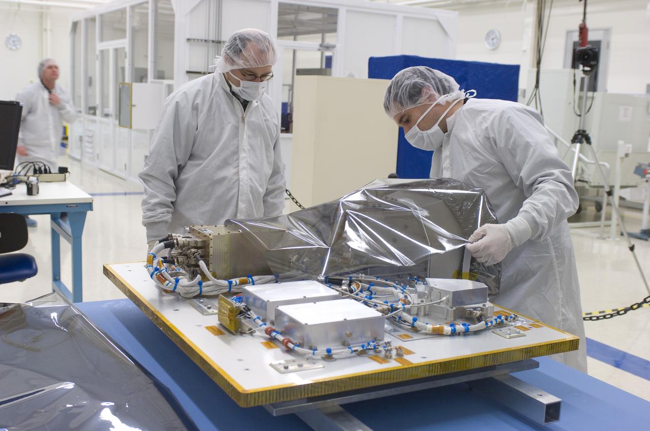 LCROSS in Ames clean room N-240- cleaning and wrapping for transfer to Northrup Grumman Redondo Beach, CA where more calibration will be done before finally being sent for mating with the LRO spacecraft (with Steve Ord, Project Management Division (l) and Tony Colaprete (r) LCROSS P.I.)