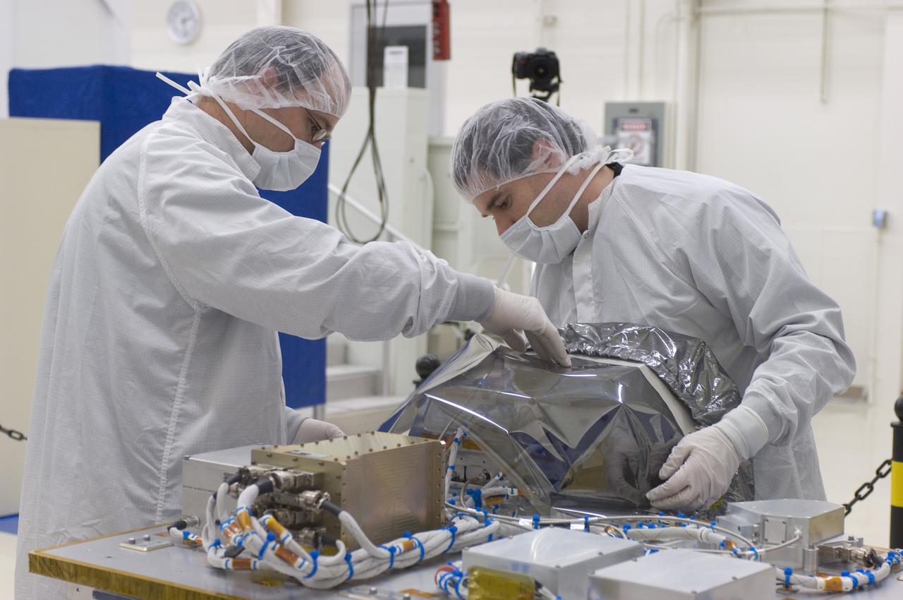 LCROSS in Ames clean room N-240- cleaning and wrapping for transfer to Northrup Grumman Redondo Beach, CA where more calibration will be done before finally being sent for mating with the LRO spacecraft (with Steve Ord, Project Management Division (l) and Tony Colaprete (r) LCROSS P.I.)