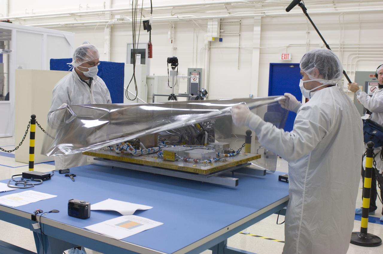 LCROSS in Ames clean room N-240- cleaning and wrapping for transfer to Northrup Grumman Redondo Beach, CA where more calibration will be done before finally being sent for mating with the LRO spacecraft (with Steve Ord, Project Management Division (l) and Tony Colaprete (r) LCROSS P.I.)