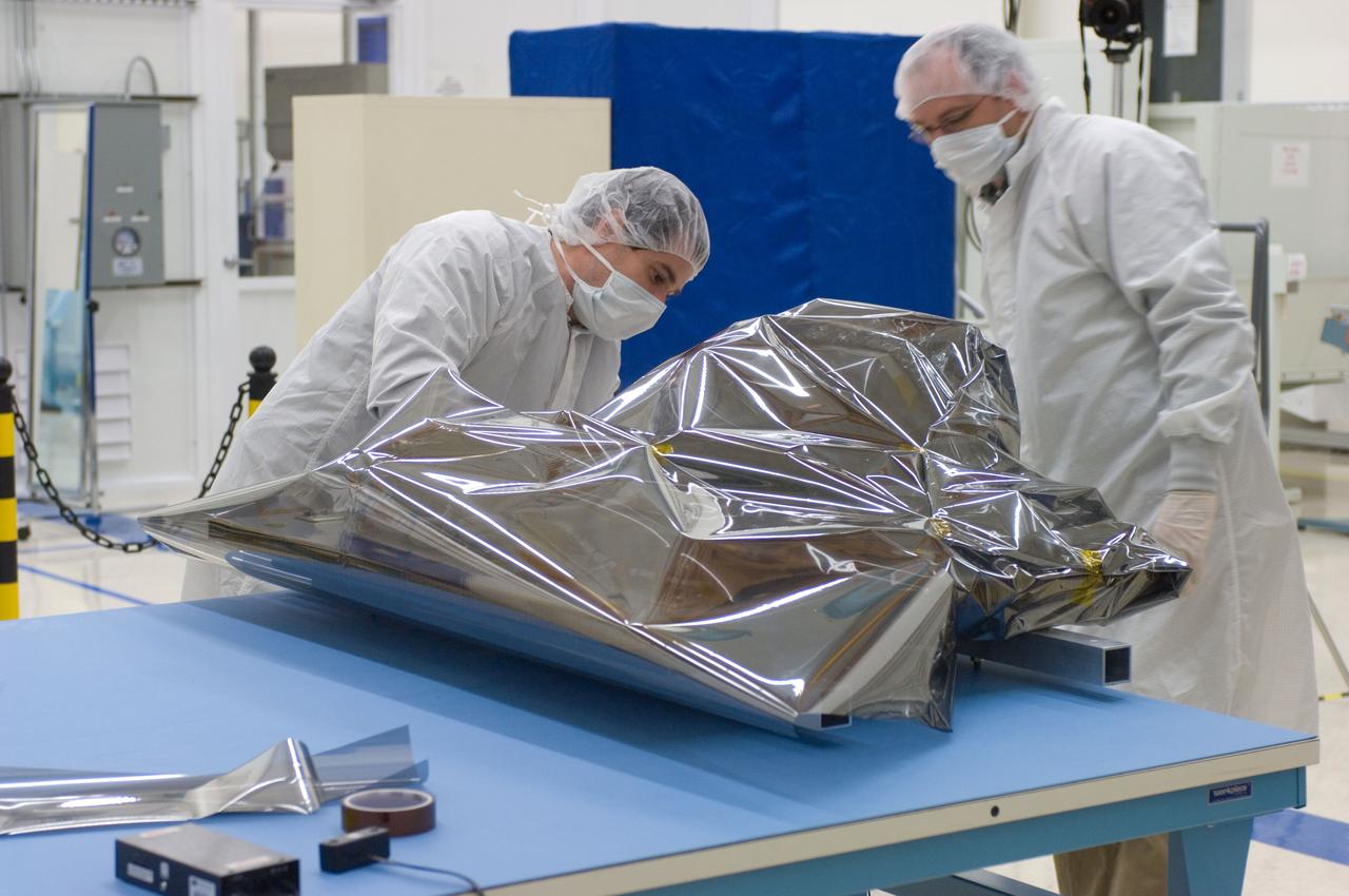LCROSS in Ames clean room N-240- cleaning and wrapping for transfer to Northrup Grumman Redondo Beach, CA where more calibration will be done before finally being sent for mating with the LRO spacecraft (with Steve Ord, Project Management Division (l) and Tony Colaprete (r) LCROSS P.I.)