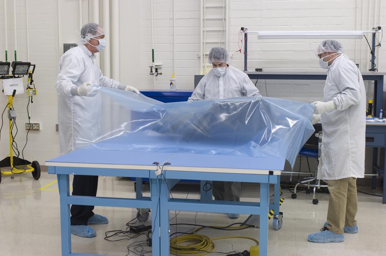 LCROSS in Ames clean room N-240- wrapping for transfer to Northrup Grumman Redondo Beach, CA where more calibration will be done before finally being sent for mating with the LRO spacecraft (with Steve Ord, Project Management Division (l) and Tony Colaprete (r), LCROSS P.I.)