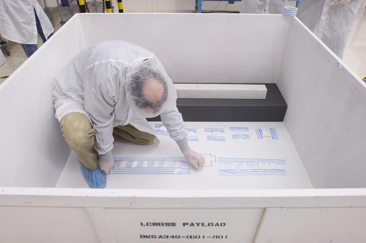 LCROSS in Ames clean room N-240- Steve Ord inspects special made crate for transfer to Northrup Grumman Redondo Beach, CA where more calibration will be done before finally being sent for mating with the LRO spacecraft