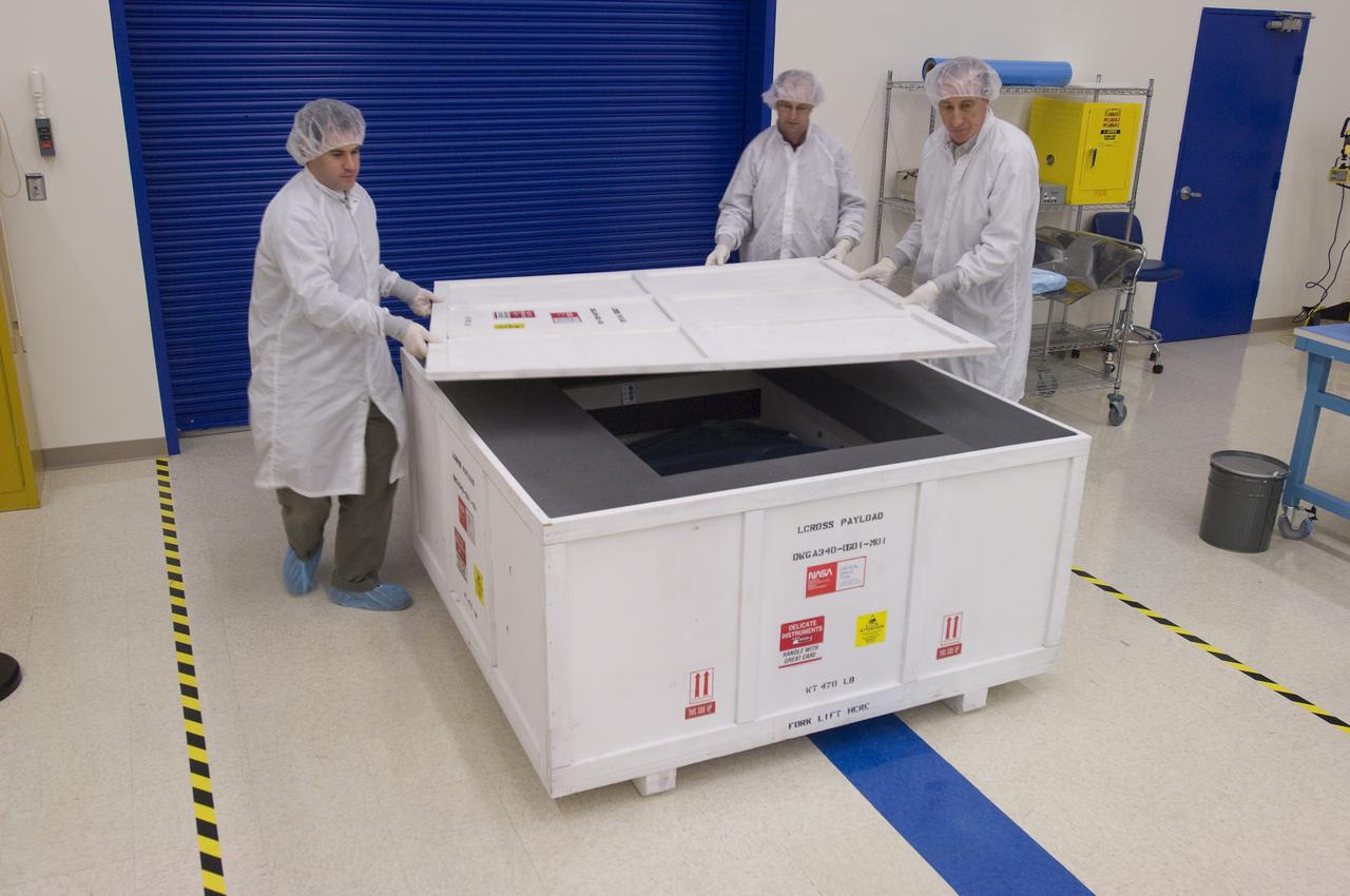 LCROSS in Ames clean room N-240- securing special made crate for transfer to Northrup Grumman Redondo Beach, CA where more calibration will be done before finally being sent for mating with the LRO spacecraft (with Tony Colaprete (l) LCROSS P.I. Steve Ord, Project Management Division (c) ) and Unknown)