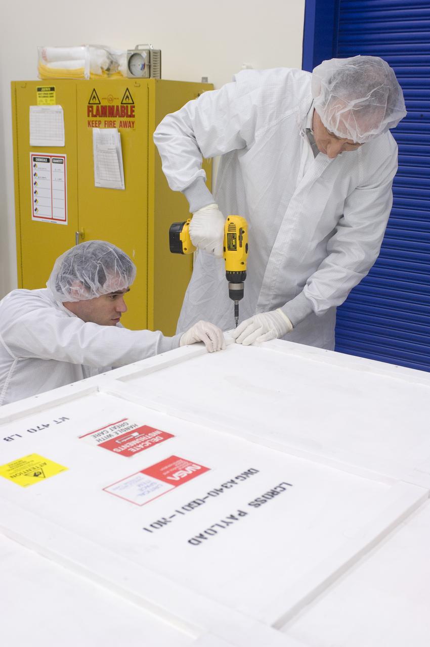 LCROSS in Ames clean room N-240- securing special made crate for transfer to Northrup Grumman Redondo Beach, CA where more calibration will be done before finally being sent for mating with the LRO spacecraft