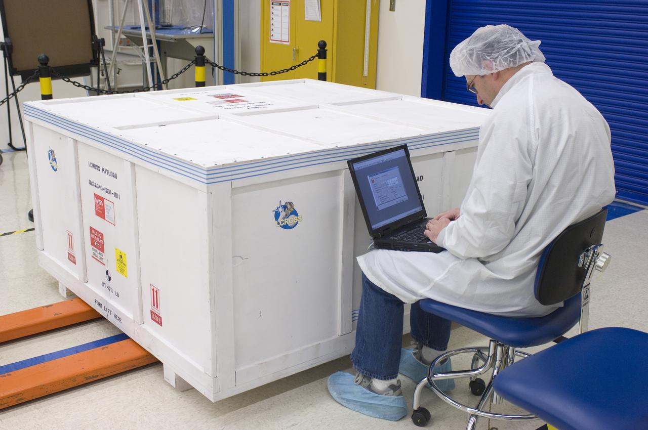 LCROSS in Ames clean room N-240- securing the special made crate for transfer to Northrup Grumman Redondo Beach, CA where more calibration will be done before finally being sent for mating with the LRO spacecraft with Steve Ord, Ames Project Management Office