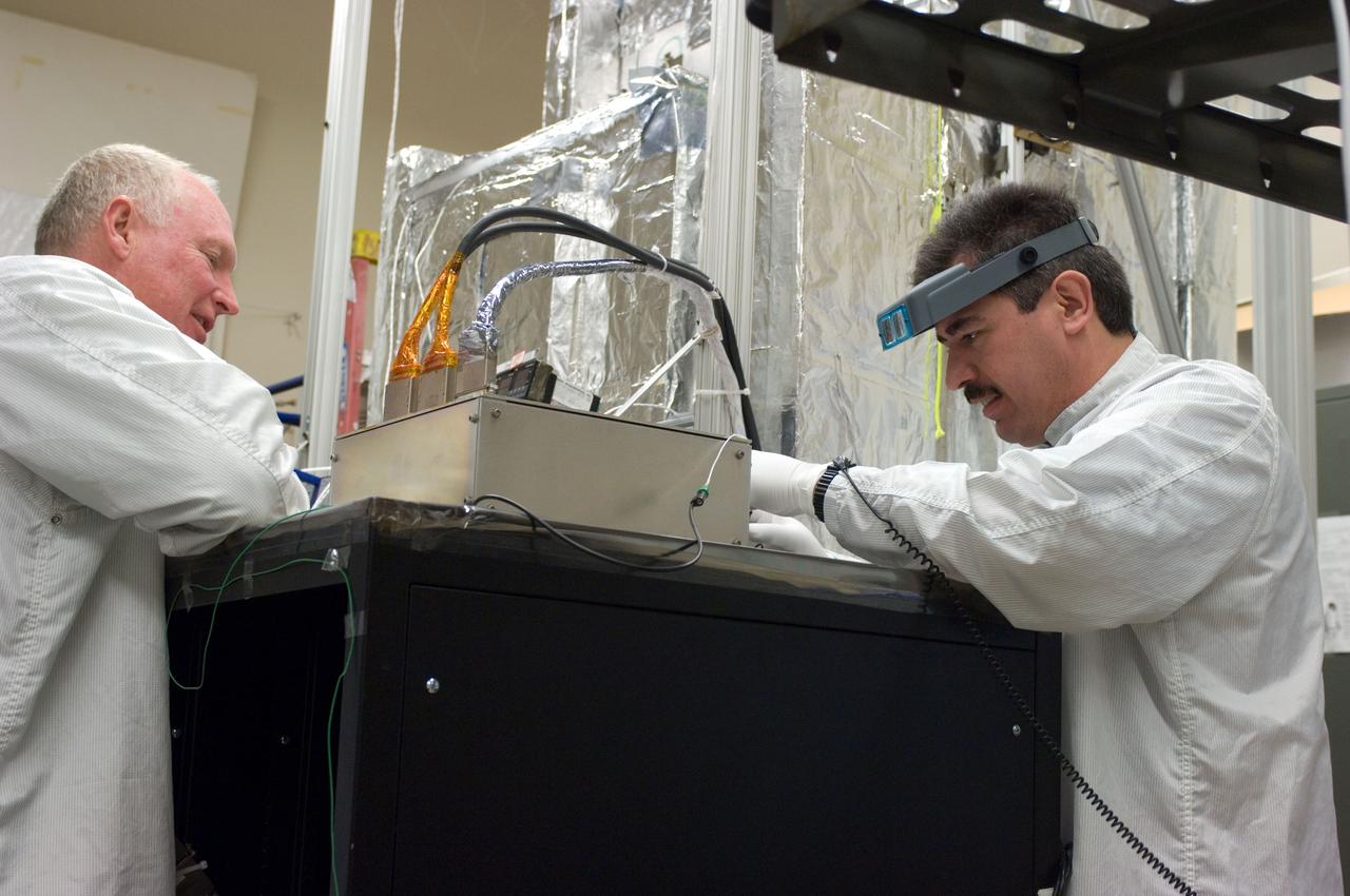 Kepler project; technicians from Ball Aerospace work on  and in the test chamber assembled at Nasa Ames Research center testing components