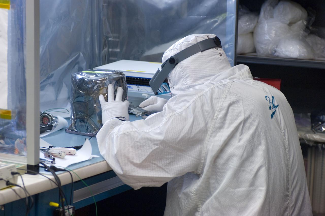 Kepler project; technicians from Ball Aerospace work on  and in the test chamber assembled at Nasa Ames Research center testing components