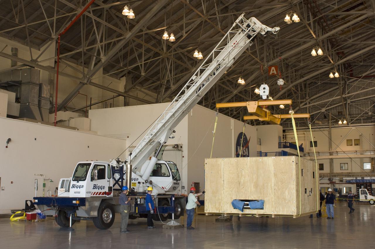 SOFIA (Stratospheric Observatory for Infrared Astronomy) primary mirror being moved into N-211, readied and move into the Ames Vacuum Chamber for the coating process.