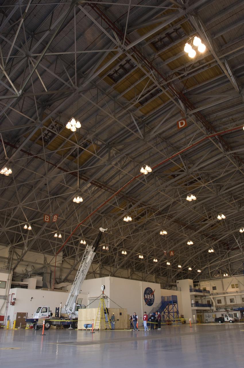 SOFIA (Stratospheric Observatory for Infrared Astronomy) primary mirror being moved into N-211, readied and move into the Ames Vacuum Chamber for the coating process.