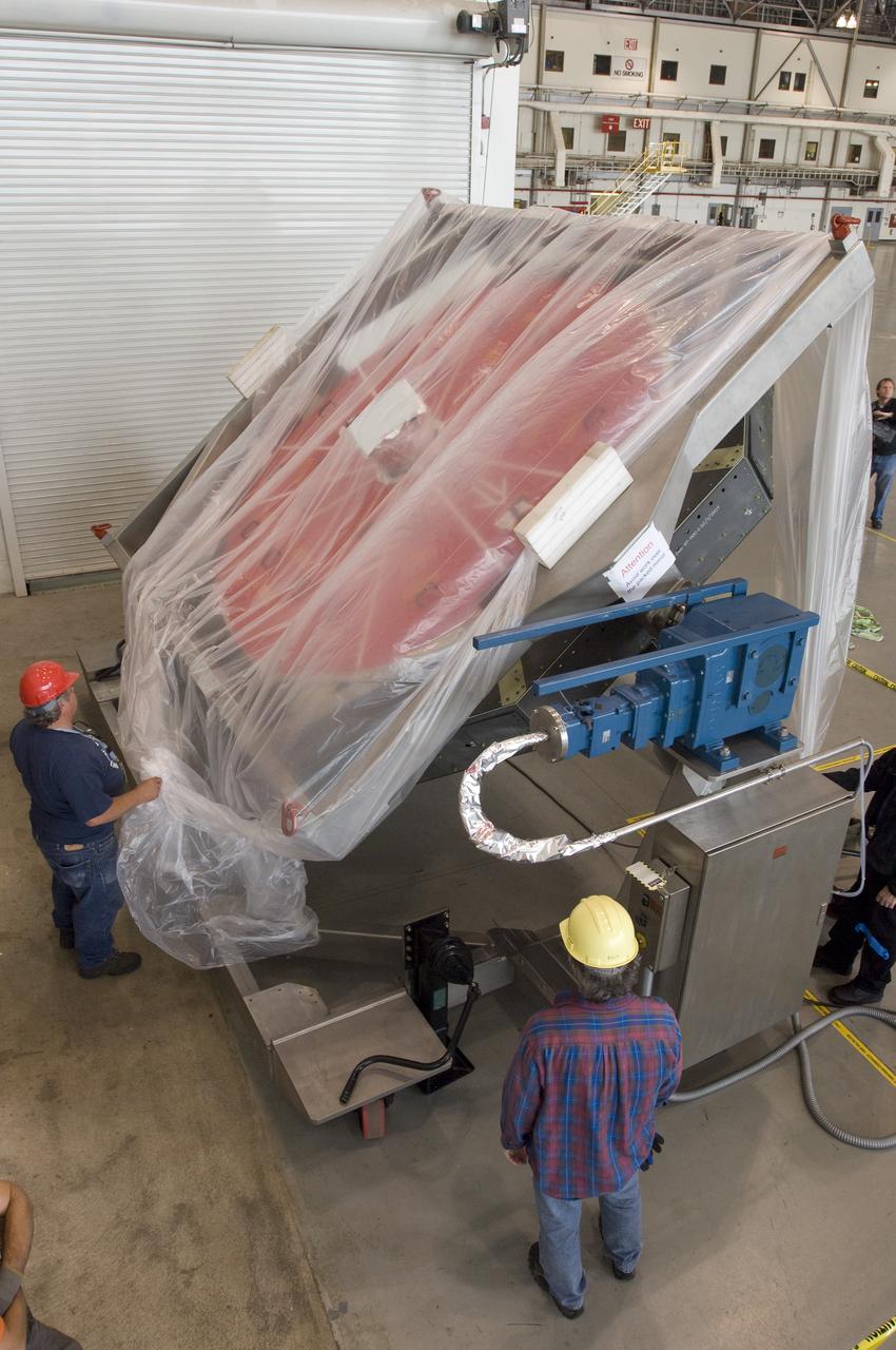 SOFIA (Stratospheric Observatory for Infrared Astronomy) primary mirror being moved into N-211, readied and move into the Ames Vacuum Chamber for the coating process.