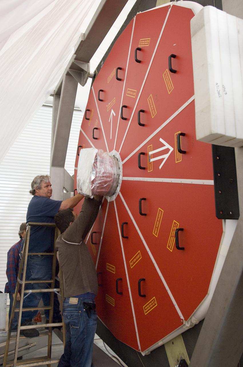 SOFIA (Stratospheric Observatory for Infrared Astronomy) primary mirror being moved into N-211, readied and move into the Ames Vacuum Chamber for the coating process.