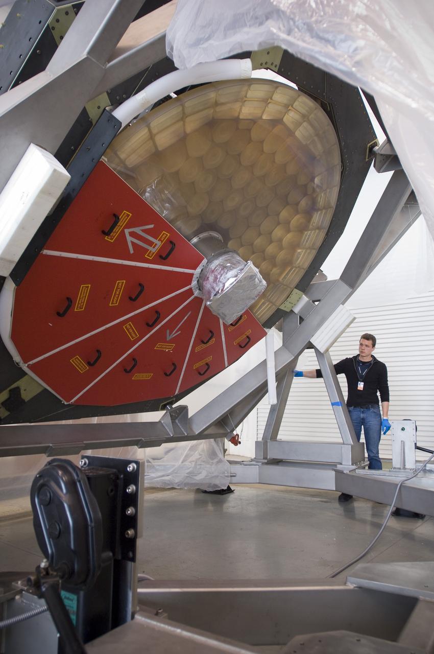 SOFIA (Stratospheric Observatory for Infrared Astronomy) primary mirror being moved into N-211, readied and move into the Ames Vacuum Chamber for the coating process.