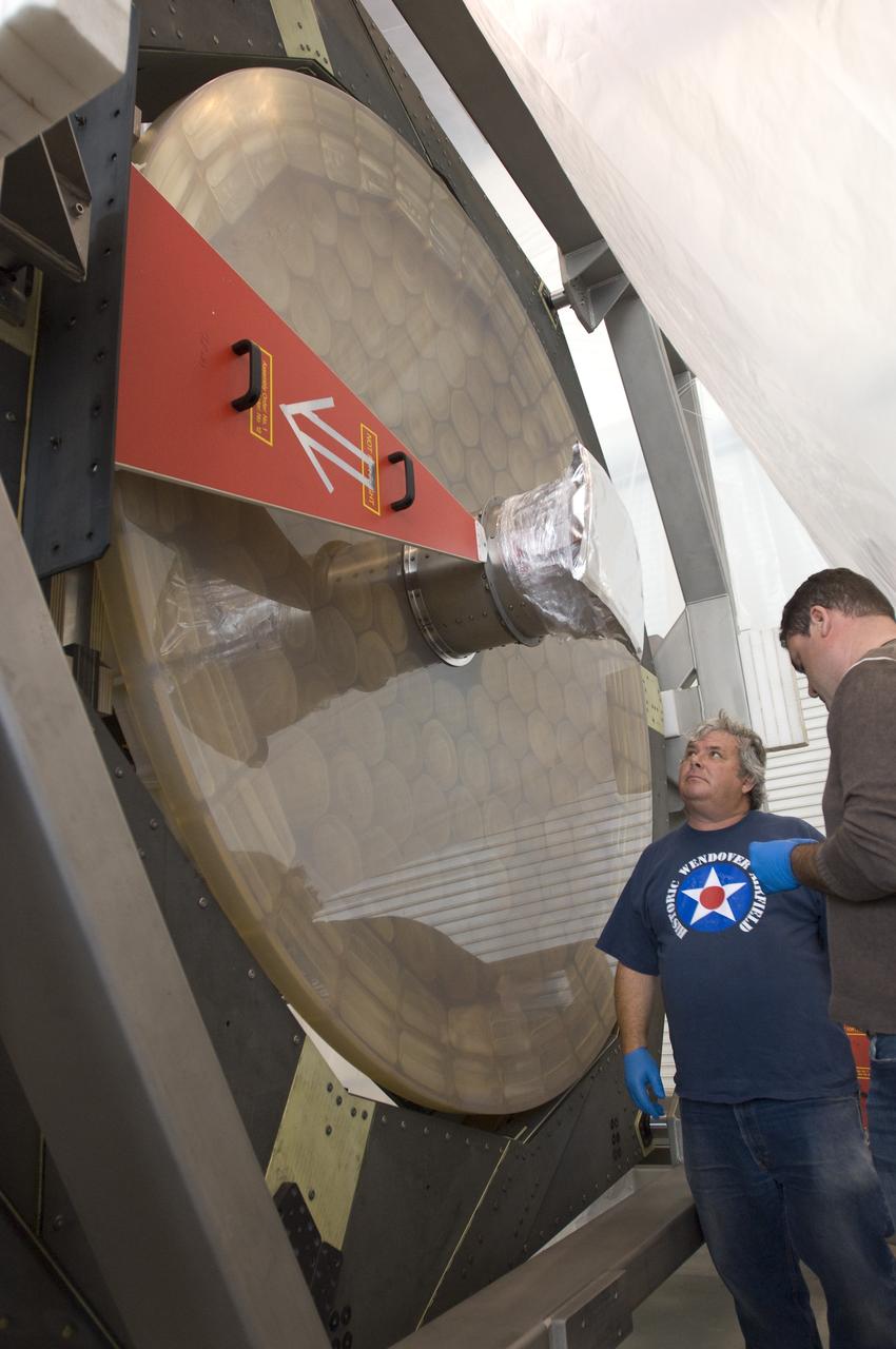 SOFIA (Stratospheric Observatory for Infrared Astronomy) primary mirror being moved into N-211, readied and move into the Ames Vacuum Chamber for the coating process.