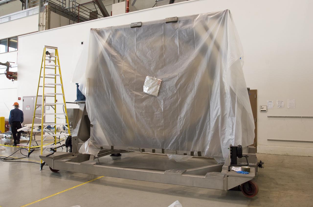 SOFIA (Stratospheric Observatory for Infrared Astronomy) primary mirror being moved into N-211, readied and move into the Ames Vacuum Chamber for the coating process.