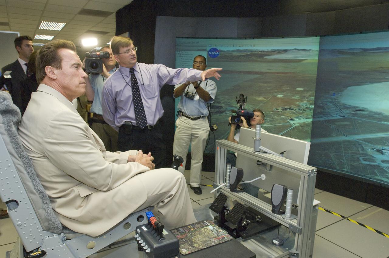 California Governor Arnold Schwarzenegger get a briefing on remote sensing fire fighting from Steve Hipskind, Chief of Ames Earth Science Division