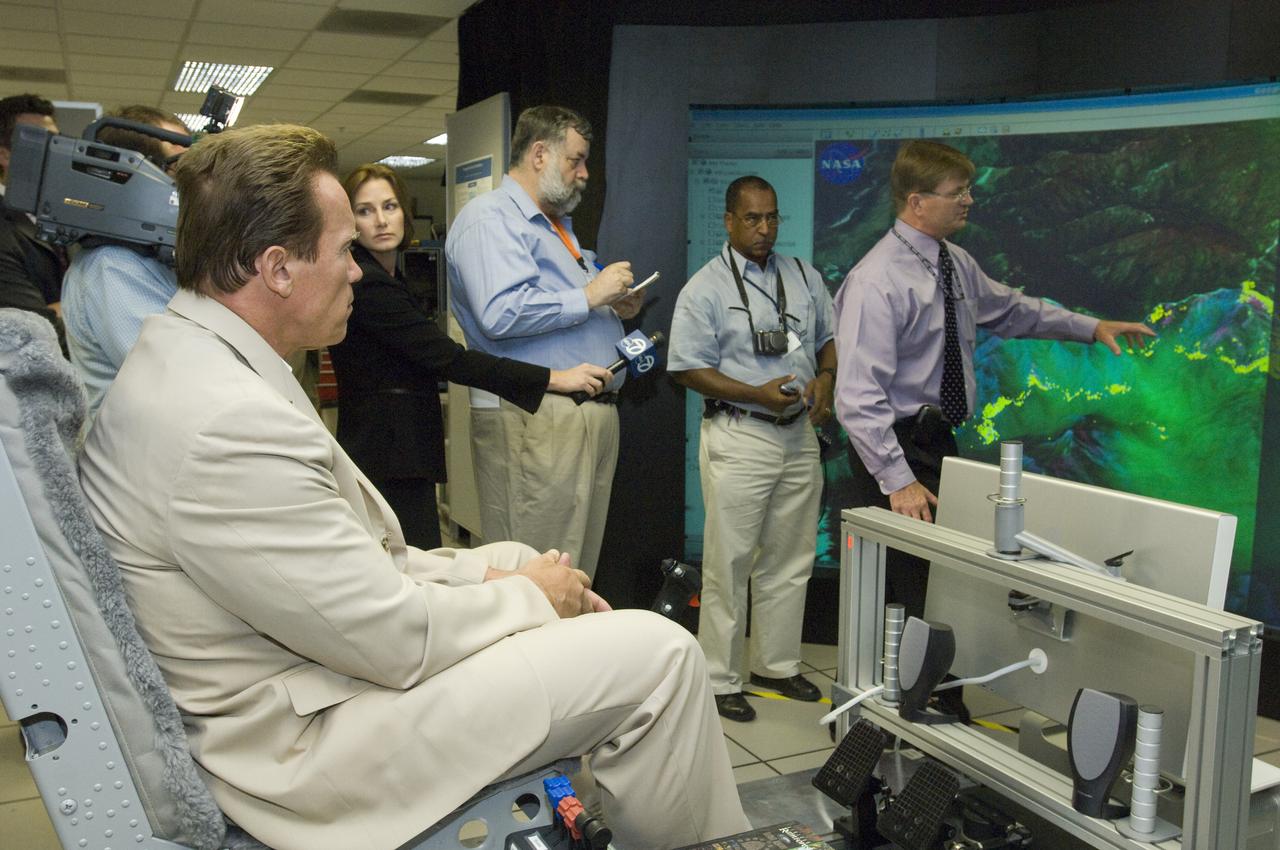 California Governor Arnold Schwarzenegger get a briefing on remote sensing fire fighting from Steve Hipskind, Chief of Ames Earth Science Division