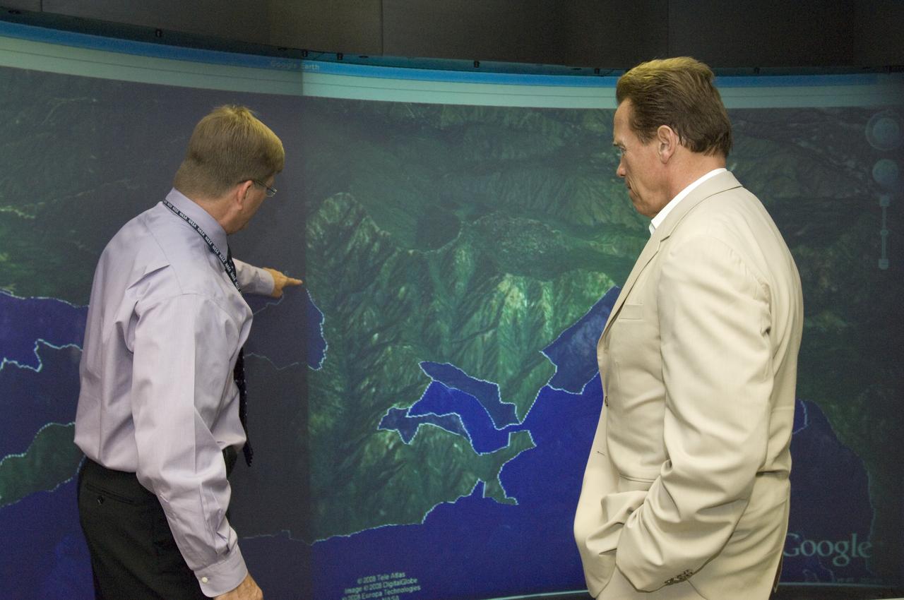 California Governor Arnold Schwarzenegger get a briefing on remote sensing fire fighting from Steve Hipskind, Chief of Ames Earth Science Division