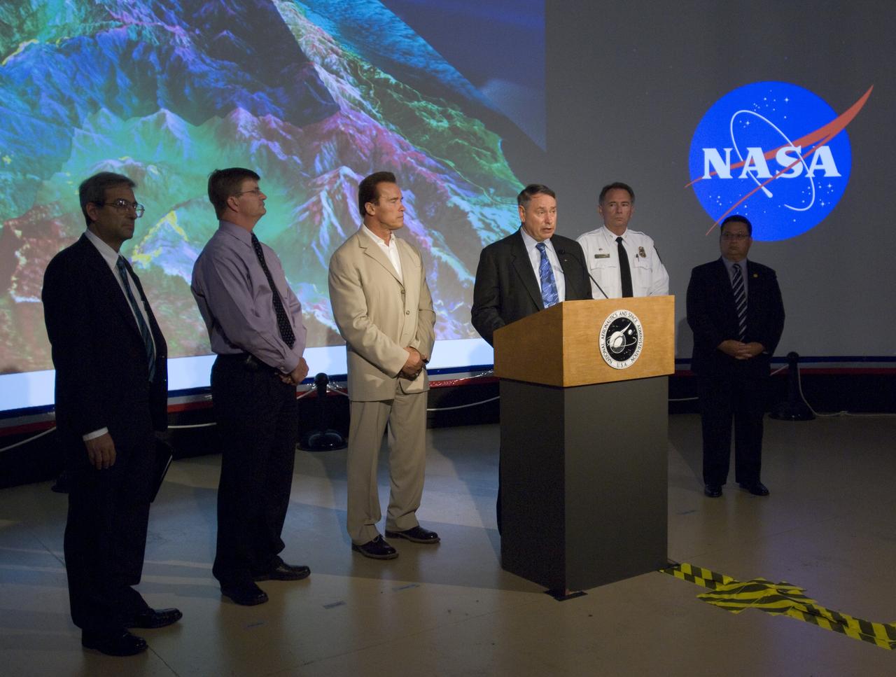 California Governor Arnold Schwarzenegger during a press briefing following a visit to Ames Earth Science Division for a briefing by Steve Hipskind on NASA Ames remote sensing fire fighting efforts.  Also shown left to right, Mike Freilich, Director, NASA Earth Sceinces Division, Steve Hipskind, Pete Worden, Governor Schwarzenegger, Chief Del Walters, Assistant Region Fire Chief, California Department of Forestry and Fire Protection, Tom Maruyama, Deputy Director, Office of Emergency Services