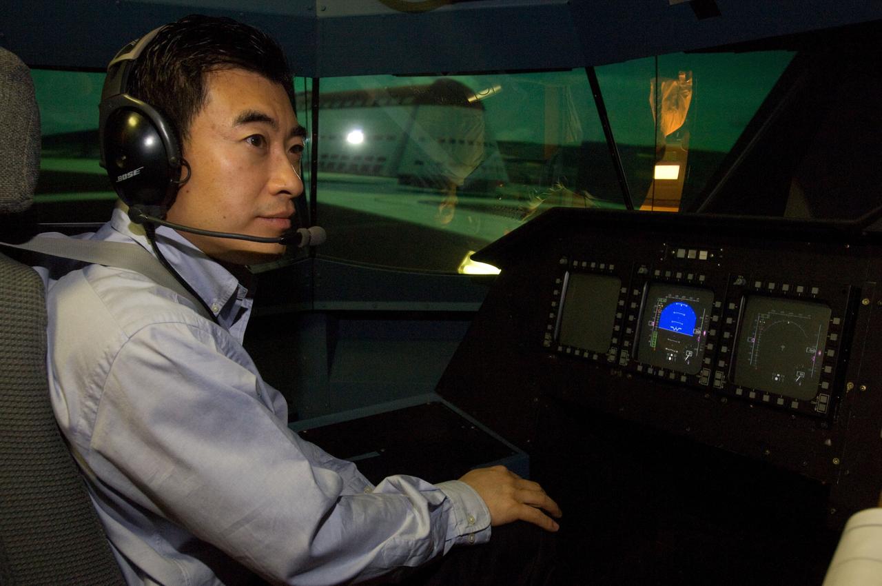 NASA AA - Associate Administrator for Aeronautics Jai Shin visits Ames Research Center and tours the Vertical Motion Simulator (VMS, T-cab) Jaiwon Shin, Moffett Field Hangar 1 shows in the VMS visual scene.