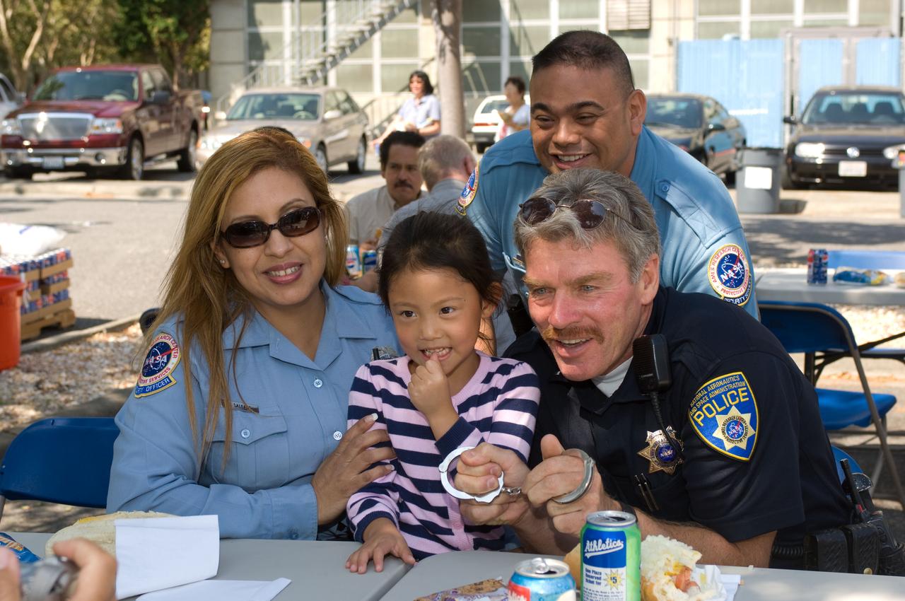 Ames Family Day Picnic in celebration of NASA's 50th Anniversary. Security Guard with daughter