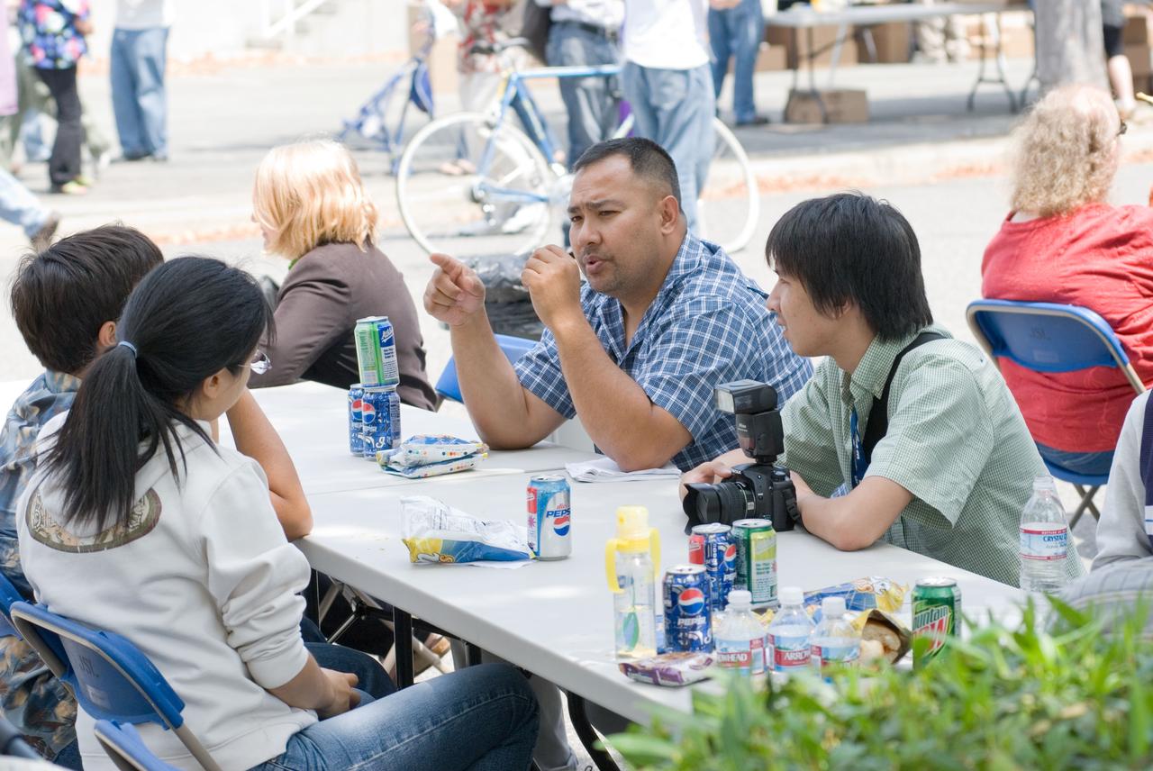 Ames Family Day Picnic in celebration of NASA's 50th Anniversary, Jonas Dino enjoy the picnic with some of the summer students from Photo. Nicholas 'Nick' Tran with camera.