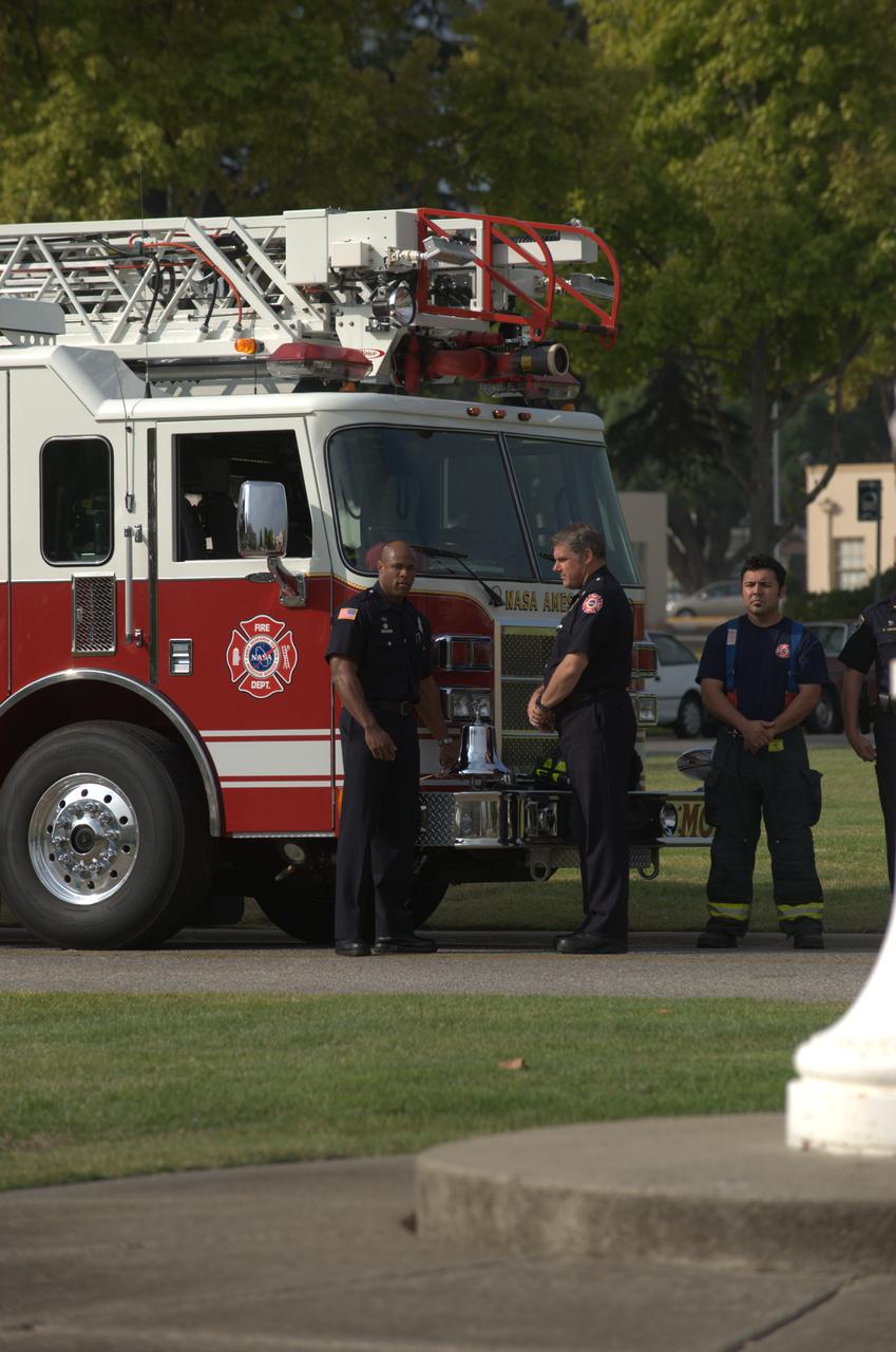 September 11th remembrance ceremony held in front of NASA Research Park Bldg-17 (Lunar Science Institute) hosted by the American Legion, Post 881, Moffett Field.  Striking of the four fives -  Moffet Fire Capt Steve Epperson (fire engine)