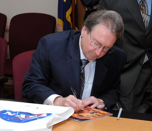 NASA's 50th Anniversay year. Panel discussion with four of NASA AMES's past center directors on how their tenure effected Ames and NASA. On the  projects they pushed for and/or pushed forward and the culture of the center and the agency and  how that worked for or against Ames, as well as major contributions of the time made by Ames Research Center.  Panel L-R; Hans Mark, Sy Syvertson, Dale Compton, Scott Hubbard and Pete Worden, present director. (Past Directors served for periods from 1969 thru 2006)  Scott Hubbard signing a Time Magazine cover with a story about NASA's Mission to Mars. for a Space fan from Flordia.