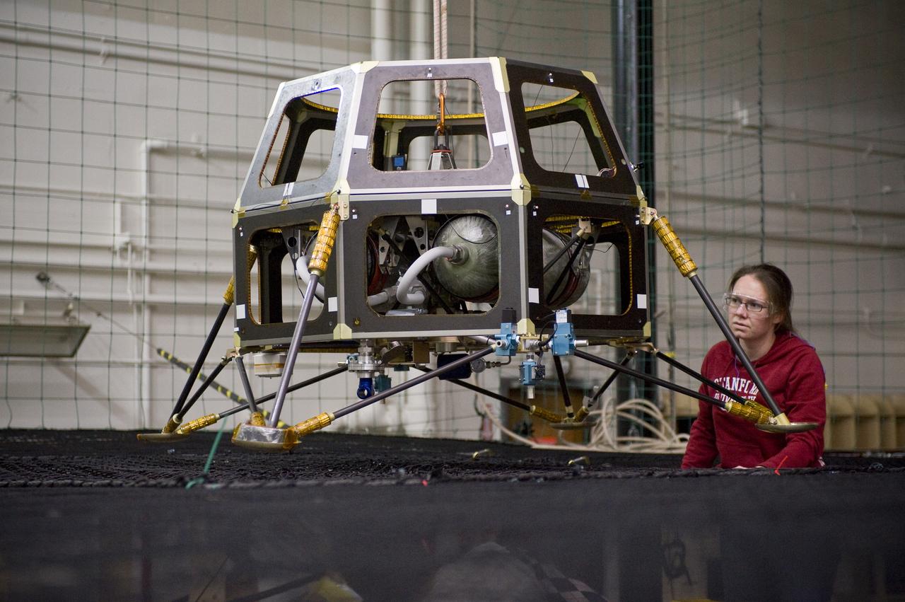 Lunar Atmosphere and Dust Environment Explorer (LADEE) Project in Building 45 Modular Common Spacecraft Bus as a hover test vehicle, here they are installing spacecraft electronics & payloads.  With Eleanor Crane.