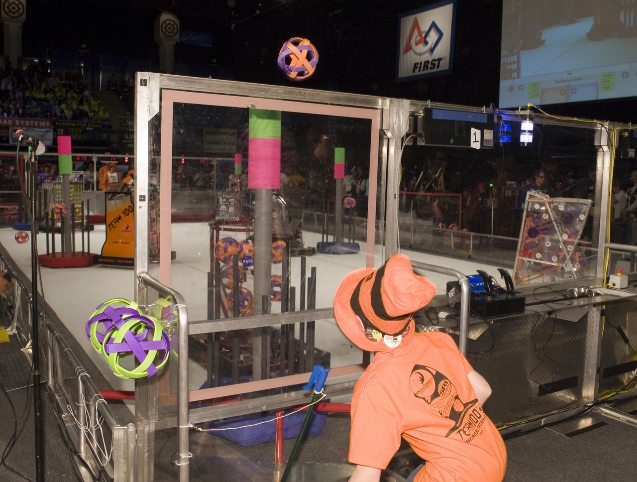 FIRST Robotics Competition  'Lunacy'  hosted by NASA at San Jose State University Event Center. For Inspiration and Recognition of Science and Technology let the games begin. the Wild Hats team #100  take a sideways vies of their bot on the field
